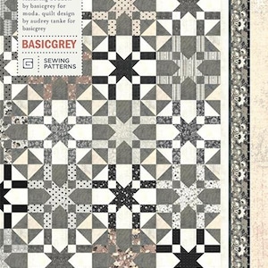 May include: A quilt pattern called "Starry Night" by BasicGrey featuring a geometric design with black, white, and gray stars and squares.