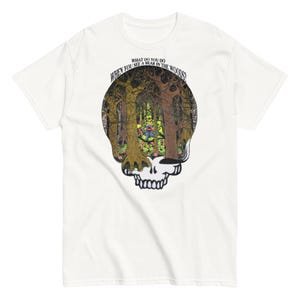 May include: White t-shirt with a graphic of a skull with a forest scene inside. The text "WHEN YOU SEE A BEAR IN THE WOODS" is printed around the skull.