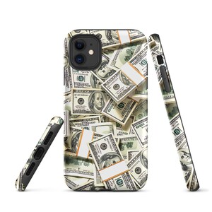 May include: A black phone case with a design of US dollar bills. The case has a camera cutout and a raised lip around the edges.