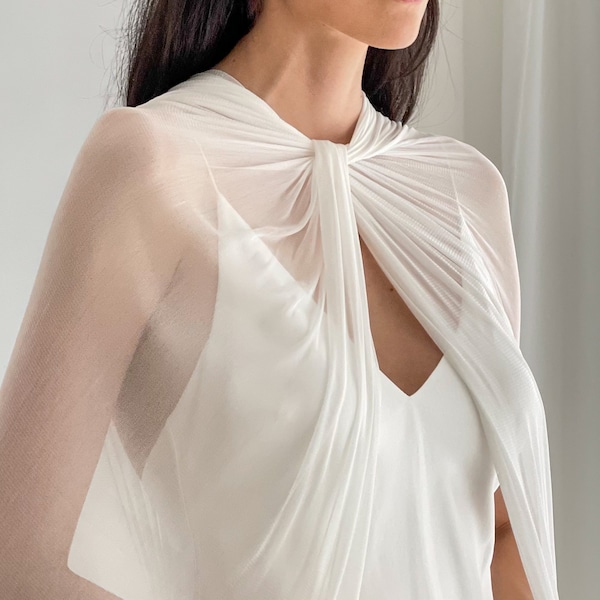 Minimalist bridal cape featuring a contemporary twist neck in a sheer silk tulle, a modern elevated bridal accessory look  style BEX