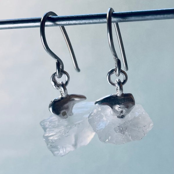 Earring of polar bear on ice Berg made from silver and quarts.