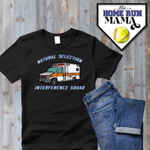 May include: Black t-shirt with a white ambulance graphic and the text "Natural Selection Interference Squad".