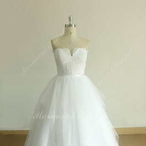 Romantic white A line tulle vintage lace wedding dress with sweetheart neckline and assymetric ruffles