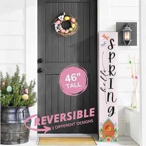 May include: A pink and white wooden sign with the text "hello spring" and a birdhouse with a bird on it. The sign is 46 inches tall and reversible with two different designs.