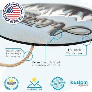 May include: A round wooden sign with a blue background and white text that reads "Love the Mountains". The sign is 1/4 inch thick and has a twine rope for hanging. It is made in the USA and features a UV-protected, sustainable design.