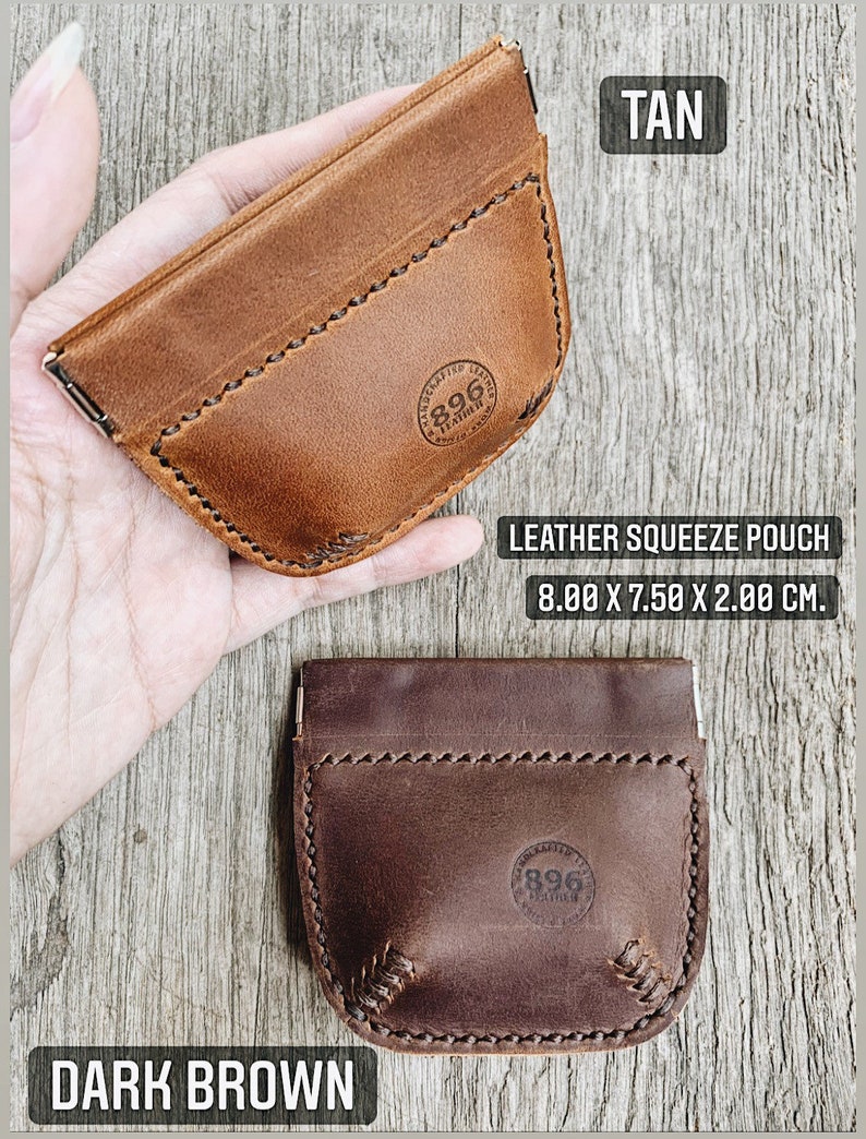 May include: Two leather squeeze pouches, one tan and one dark brown. Both pouches have a stitched design and a circular logo with the text "896 Leather" inside. The pouches are 8 inches by 7.5 inches by 2 inches.