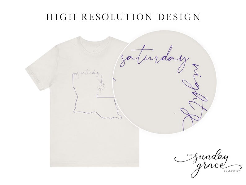 May include: A light beige short-sleeve t-shirt featuring a dark purple line art outline of the state of Louisiana. The text "saturday night" is written in a cursive script along the top edge of the state outline. A circular inset shows a magnified view.
