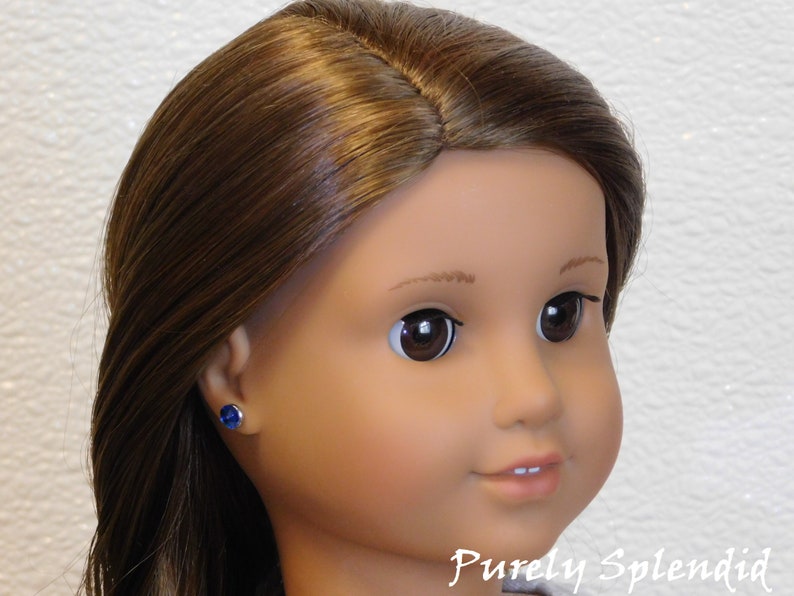 18 inch doll shown wearing a pair of Capri Blue 2mm Studs