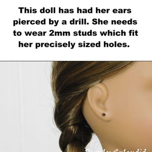 Doll who has drilled holes wears 2mm sized earrings