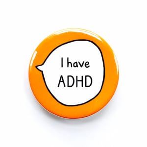 May include: Orange round button with a white speech bubble that says "I have ADHD".