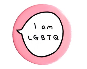 May include: Pink round button with a white speech bubble that says "I am LGBTQ".