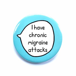 May include: A round, light blue button with the text "I have chronic migraine attacks" inside a white speech bubble. The text is in a black, sans-serif font.