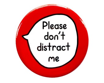 May include: Red round button with a white speech bubble that says "Please don't distract me".