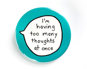May include: A turquoise blue round button with a white speech bubble that says "I'm having too many thoughts at once".