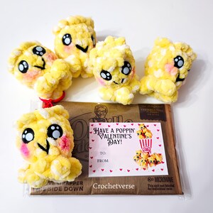 May include: Five handmade yellow popcorn plushies with black eyes, pink cheeks, and smiling faces. A Valentine's Day card with the text "Have a Poppin' Valentine's Day!" is included. The plushies are on a brown package.