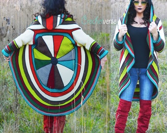 May include: A colorful crochet cardigan with a circular design on the back. The cardigan has a hood and is striped with shades of green, red, brown, white, and blue. The cardigan is shown being worn by a person in a field.
