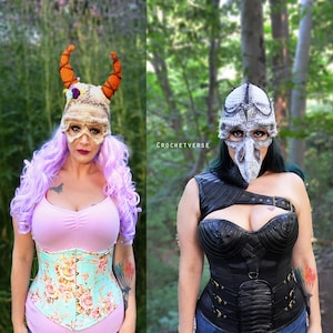 May include: Two women wearing crocheted hats with masks. The woman on the left is wearing a floral corset and a pink top. The woman on the right is wearing a black leather corset and a black top. The text "CROCHETVERSE" is visible in the image.