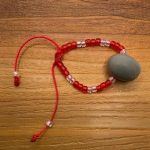 Bracelet mauvais œil (Ojo de Venado) - Salvador - Rouge et clair transparents - Taille enfant ajustable