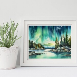 May include: A watercolour painting of a forest scene with a lake in the foreground and the aurora borealis in the sky. The painting is framed in a white frame.