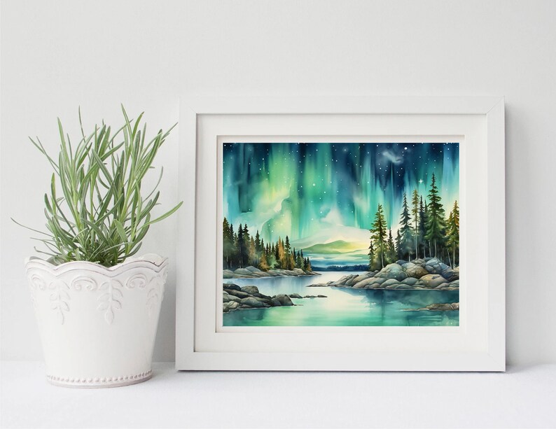 May include: A watercolour painting of a forest scene with a lake in the foreground and the aurora borealis in the sky. The painting is framed in a white frame.