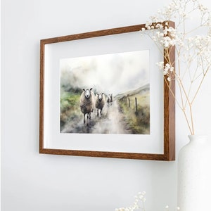 May include: A watercolor painting of a group of sheep walking down a path in a misty landscape. The sheep are white with brown markings and are walking in a line. The path is dirt and the landscape is green and brown.