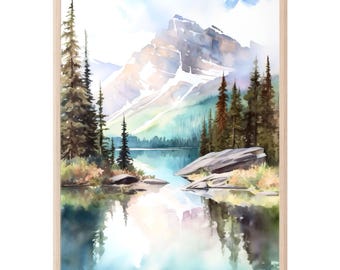 May include: A framed watercolor painting depicting a mountain landscape with a calm lake in the foreground. The scene features tall evergreen trees, rocky shorelines, and a snow-capped mountain peak reflecting in the water, all encased in a light wood frame.