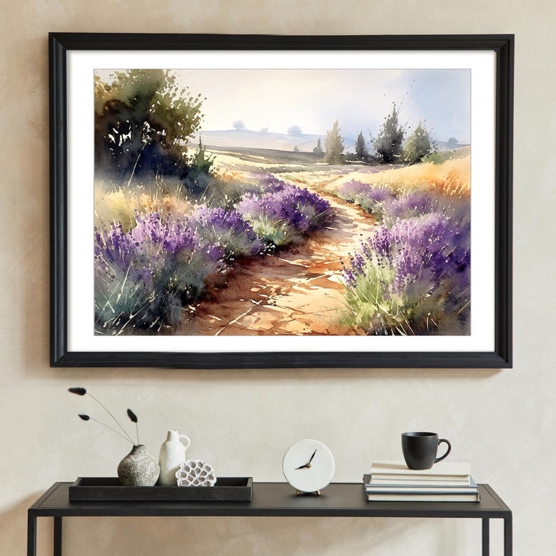 May include: A framed watercolour painting of a lavender field with a dirt path leading through it. The painting is set against a light blue sky with a few trees in the background.
