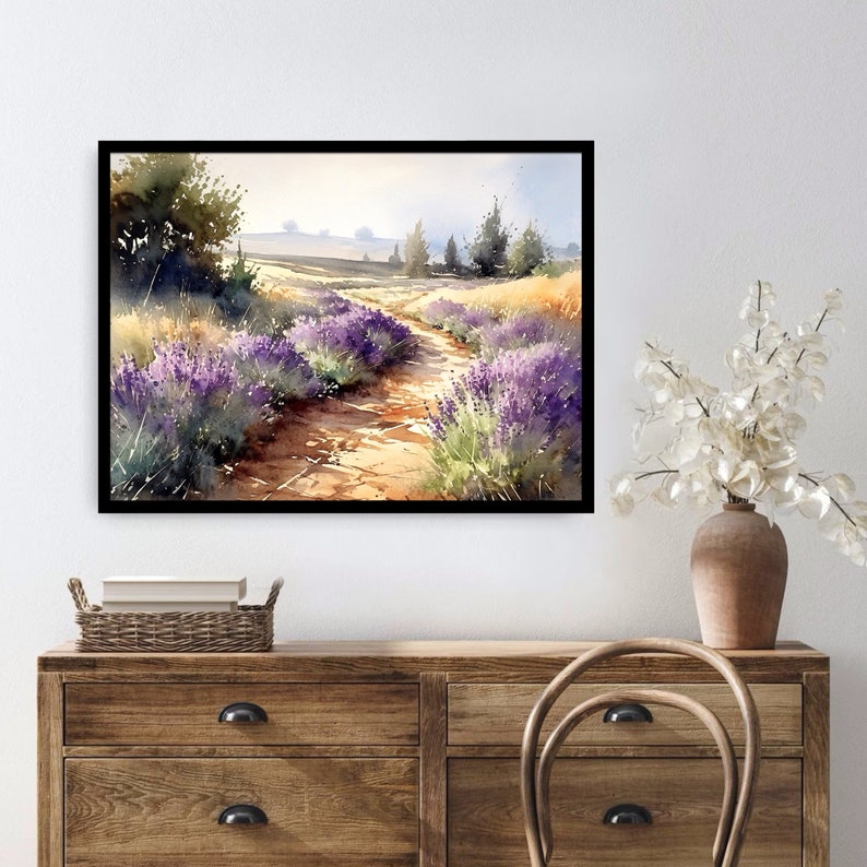 May include: A watercolour painting of a lavender field with a dirt path leading through it. The path is lined with trees and the sky is a light blue.