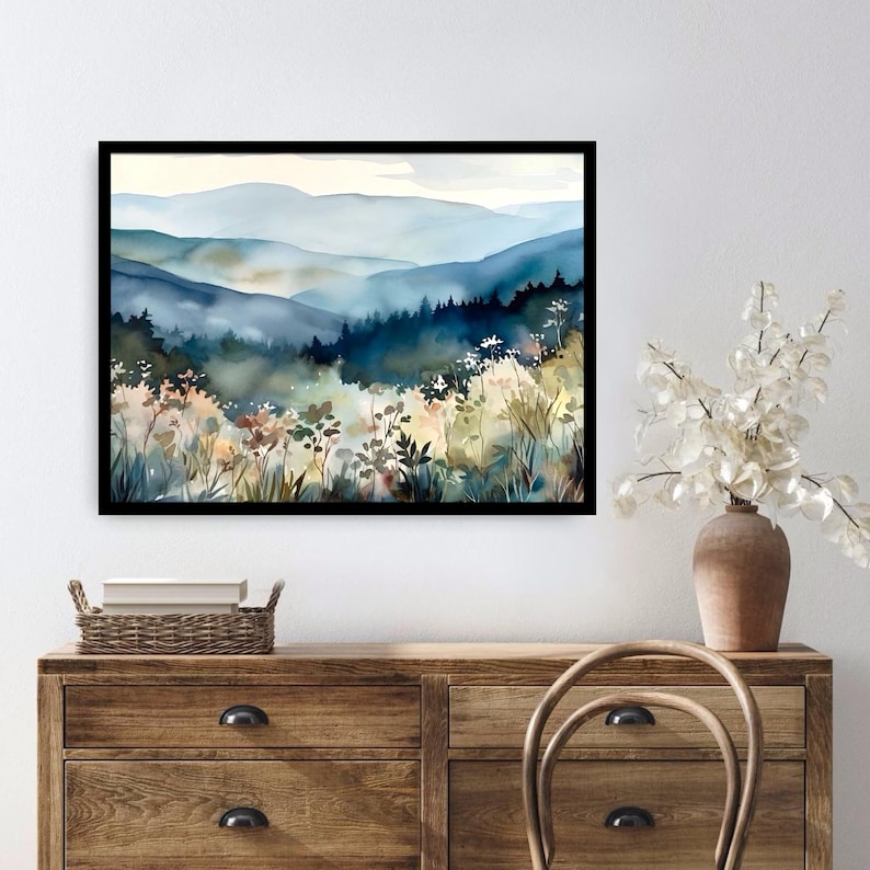 May include: A watercolor painting of a misty mountain landscape with a foreground of wildflowers in shades of blue, green, and yellow.