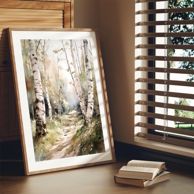 May include: A watercolor painting of a path through a birch tree forest. The path is lined with tall, white birch trees with green leaves. The painting is framed in a light brown wood frame.