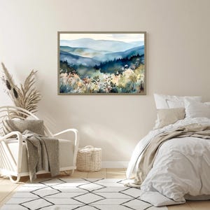 May include: A watercolor painting of a mountain landscape with blue and green hues. The painting depicts a misty mountain range with trees and wildflowers in the foreground.
