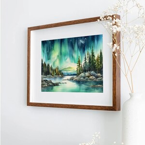 May include: A framed watercolour painting depicting a forest scene with a lake in the foreground. The sky is filled with vibrant green and blue aurora borealis. The trees are silhouetted against the colourful sky.