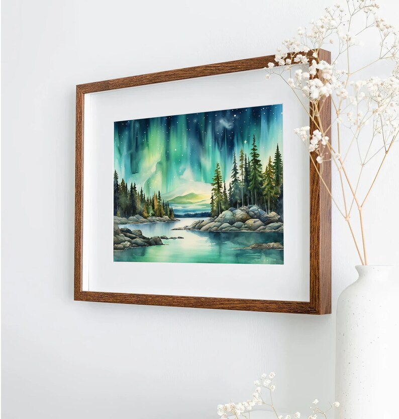 May include: A framed watercolour painting depicting a forest scene with a lake in the foreground. The sky is filled with vibrant green and blue aurora borealis. The trees are silhouetted against the colourful sky.