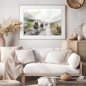 May include: A watercolor painting of a group of sheep walking down a dirt road in a foggy landscape. The sheep are white with brown markings and are walking in a single file line. The background is a soft, muted green and blue.