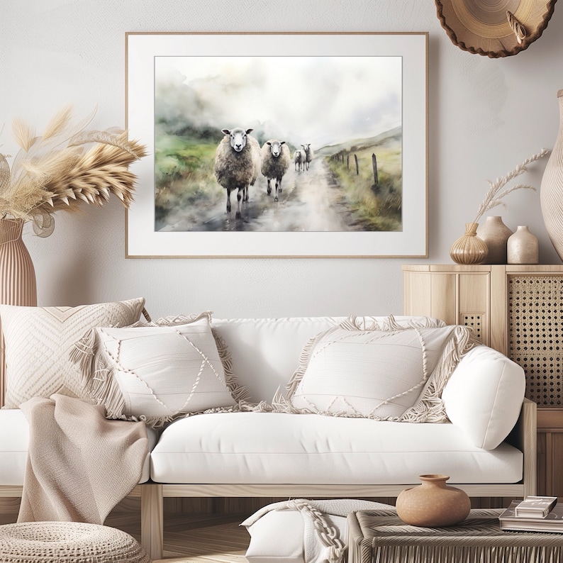 May include: A watercolor painting of a group of sheep walking down a dirt road in a foggy landscape. The sheep are white with brown markings and are walking in a single file line. The background is a soft, muted green and blue.