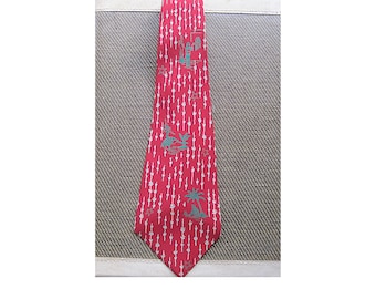 May include: A red silk tie with a white and teal pattern of palm trees and people. The pattern is repeated throughout the tie.