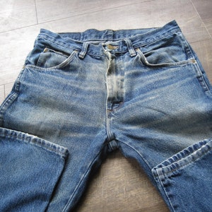 May include: A pair of blue denim jeans with a faded wash and a classic five-pocket style.