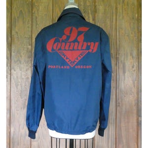 May include: A navy blue jacket with a red and white logo that says "97 Country" and "Skylite Portland Oregon".