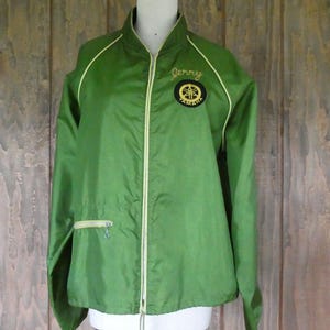 May include: Green nylon jacket with a yellow zipper and trim. The jacket has a Yamaha logo and the name "Jerry" embroidered on the front.