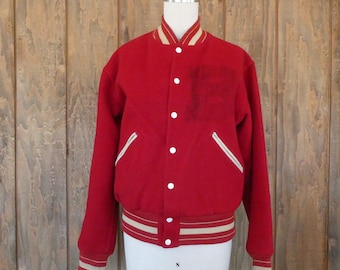 May include: A red varsity jacket with white and tan accents. The jacket has a button-up front, a chest pocket, and white-lined pockets. The collar, cuffs, and waistband feature tan and white stripes. The jacket is displayed on a mannequin.