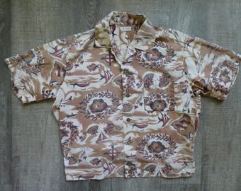 May include: Tan and cream-colored button-down shirt with a tropical print. The short-sleeved shirt features a pattern of flowers, fish, sailboats, and other nautical elements. The shirt has a collar and a single pocket.