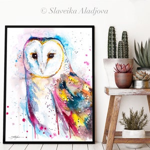 May include: Watercolor painting of a barn owl with colorful feathers. The owl's face is white with black eyes and a yellow beak. The background is a light blue with pink and yellow splatters.