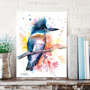 May include: Watercolor painting of a blue and purple kingfisher perched on a branch with colorful flowers and leaves. The background is white with colorful watercolor splatters.