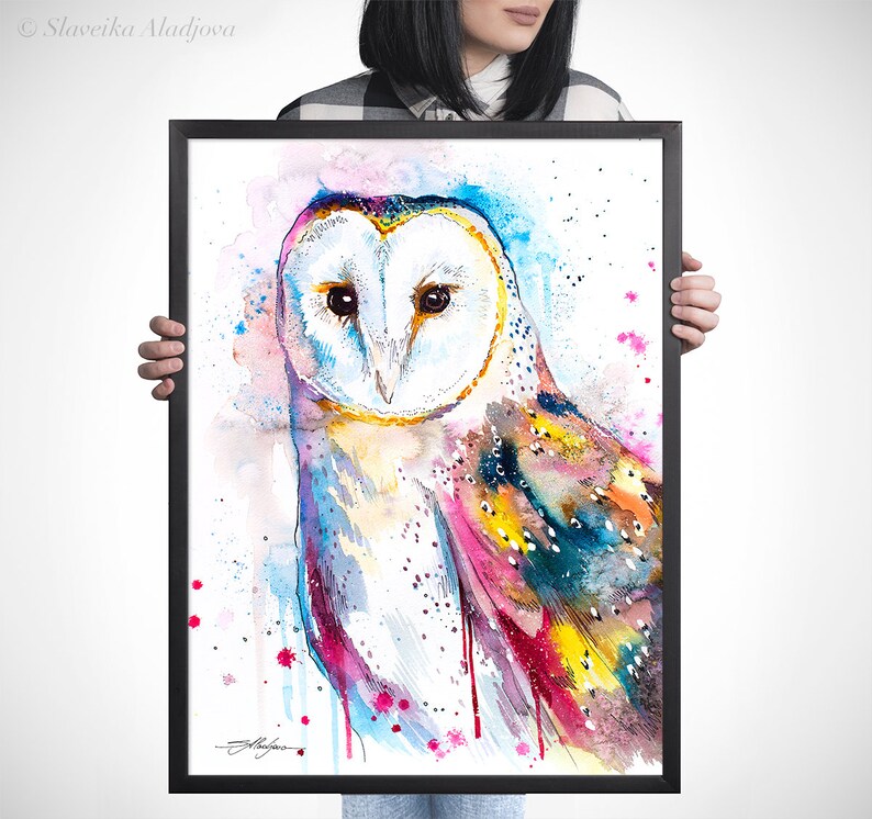 May include: A watercolor painting of a barn owl with colorful feathers and a white face. The owl is painted in shades of blue, pink, yellow, and green. The background is white with pink and blue watercolor splatters.