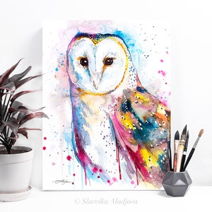 May include: Watercolor painting of a barn owl with colorful feathers and a white face. The owl is painted in shades of pink, blue, yellow, and green. The background is a light blue watercolor wash with white splatters.