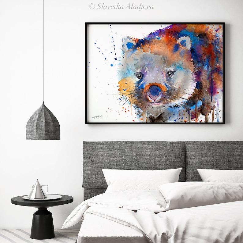 May include: Watercolor painting of a wombat with blue, orange, and purple hues. The wombat is looking directly at the viewer with a curious expression. The background is white with splatters of paint.