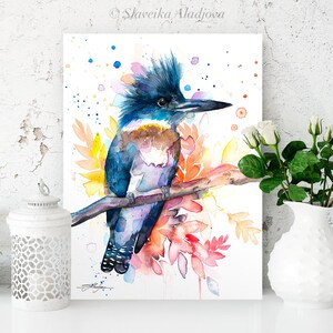 May include: Watercolor painting of a blue, purple, and brown kingfisher bird perched on a branch with colorful flowers and leaves. The background is white with watercolor splatters.