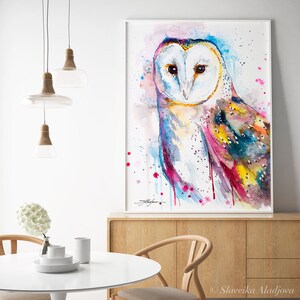 May include: Watercolor painting of a barn owl with colorful feathers and a pink, blue, and yellow background. The owl is looking directly at the viewer.
