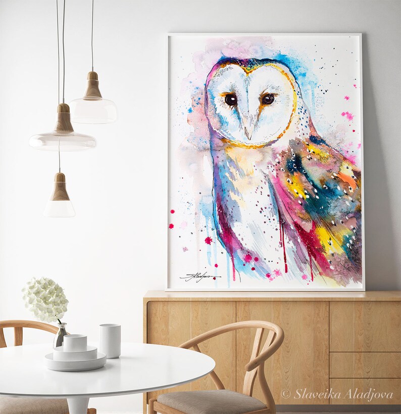 May include: Watercolor painting of a barn owl with colorful feathers and a pink, blue, and yellow background. The owl is looking directly at the viewer.