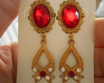 bright brass pierced bow earrings with red and clear stones